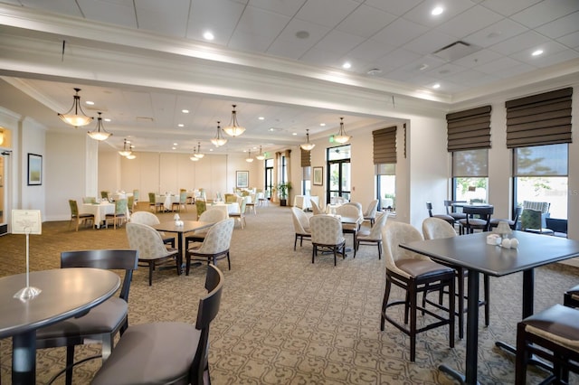 dining space with ornamental molding and light carpet