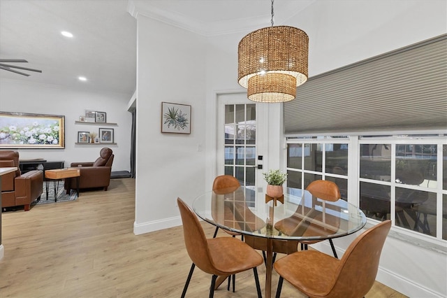 dining area featuring ceiling fan, light hardwood / wood-style floors, and ornamental molding