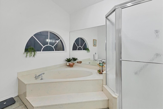 bathroom featuring tile patterned flooring, plus walk in shower, and an inviting chandelier