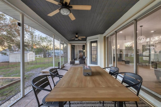 sunroom / solarium with ceiling fan and wooden ceiling