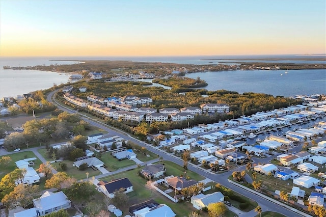 aerial view at dusk with a water view