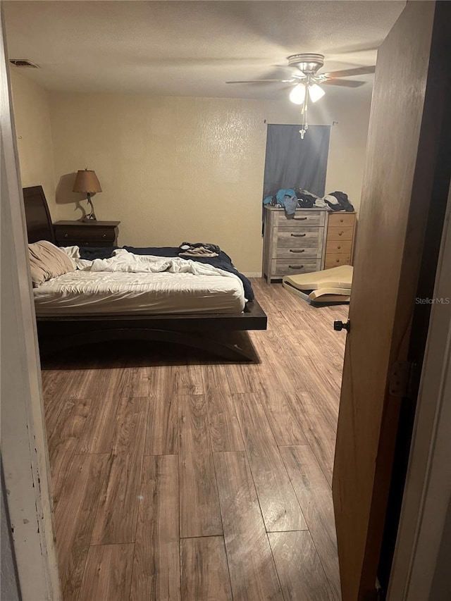 bedroom featuring hardwood / wood-style flooring and ceiling fan