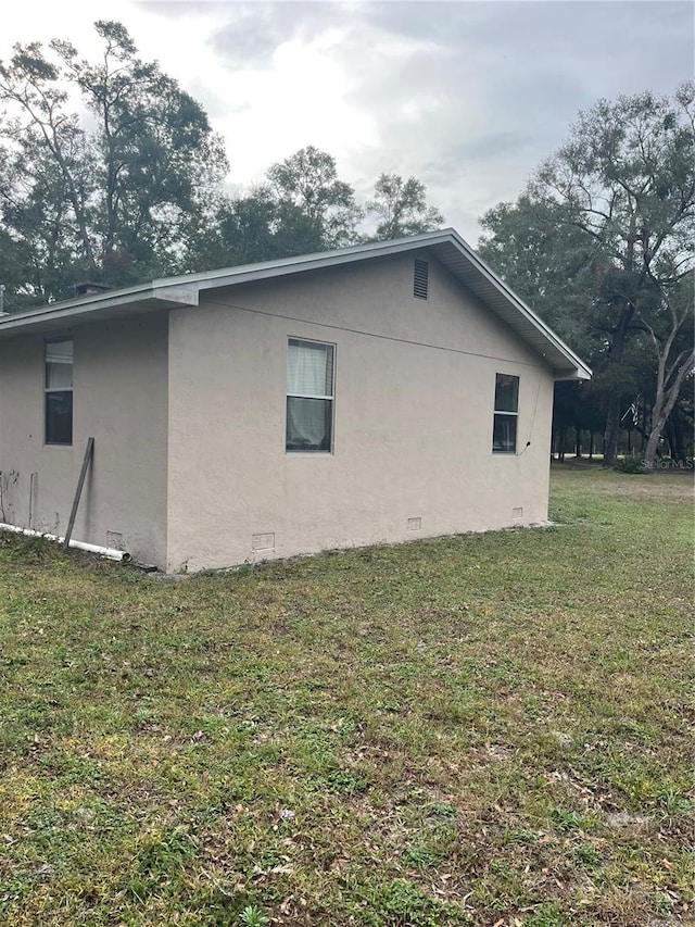 view of home's exterior with a yard