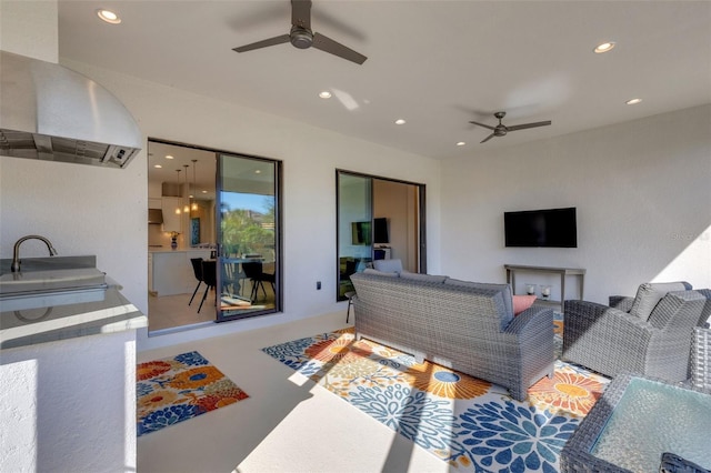 living area featuring ceiling fan and recessed lighting