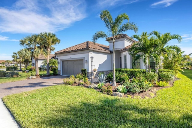 mediterranean / spanish-style house featuring decorative driveway, a tile roof, stucco siding, a front yard, and a garage