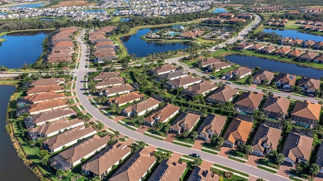 bird's eye view featuring a water view and a residential view