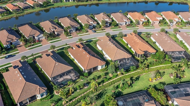 birds eye view of property with a water view and a residential view