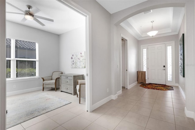 foyer with light tile patterned floors, arched walkways, and a wealth of natural light