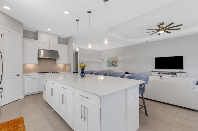 kitchen with open floor plan, light tile patterned floors, and under cabinet range hood