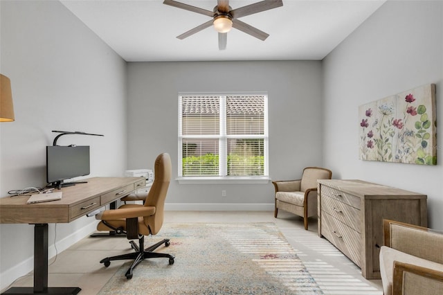 office area featuring ceiling fan, baseboards, and light tile patterned floors