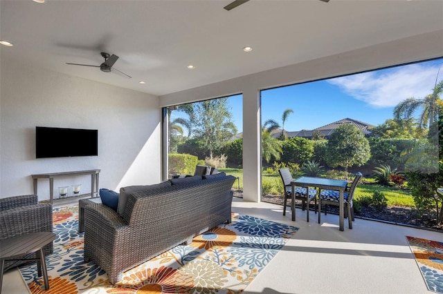 living area featuring plenty of natural light, a ceiling fan, concrete flooring, and recessed lighting