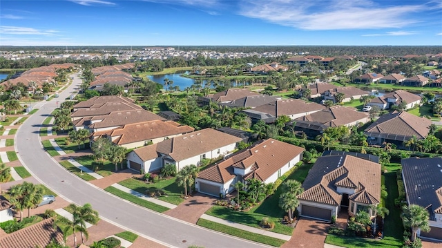 drone / aerial view featuring a water view and a residential view