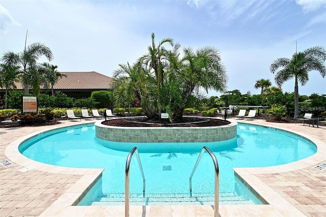 community pool with a patio area