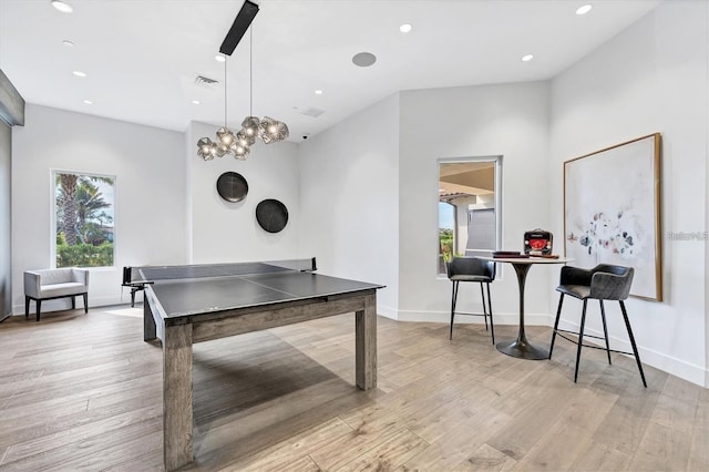 game room featuring light wood-type flooring, plenty of natural light, and recessed lighting