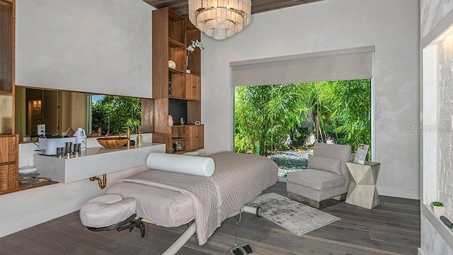 bedroom featuring a chandelier and wood finished floors