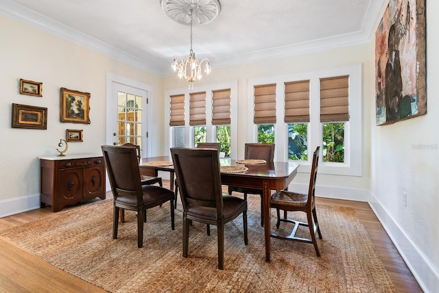 dining room featuring a chandelier, dark wood-type flooring, and ornamental molding