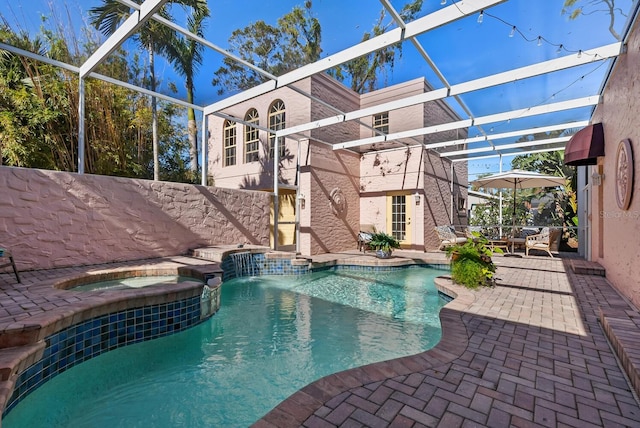 view of swimming pool featuring an in ground hot tub, a patio, and a lanai