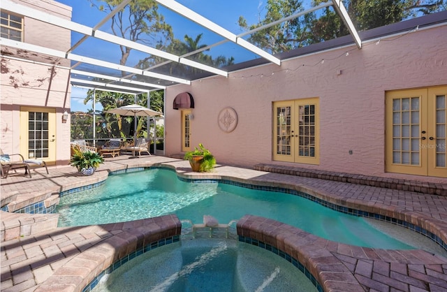 view of swimming pool featuring a lanai, an in ground hot tub, a patio, and french doors