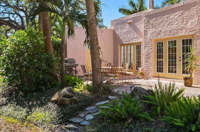 back of house with a patio area and french doors