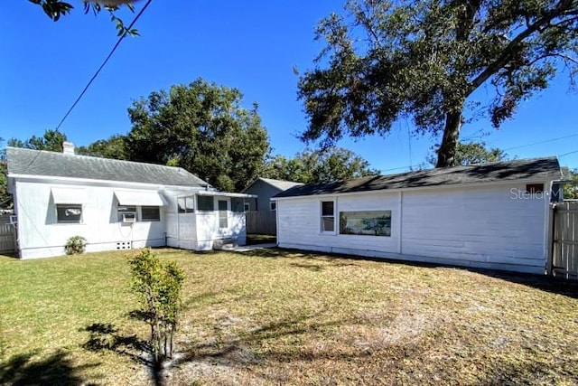 back of house featuring a lawn