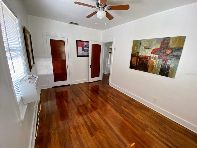 interior space with dark hardwood / wood-style flooring, ceiling fan, and a healthy amount of sunlight