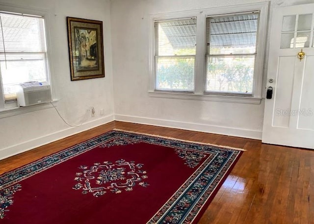 interior space featuring wood-type flooring and baseboards