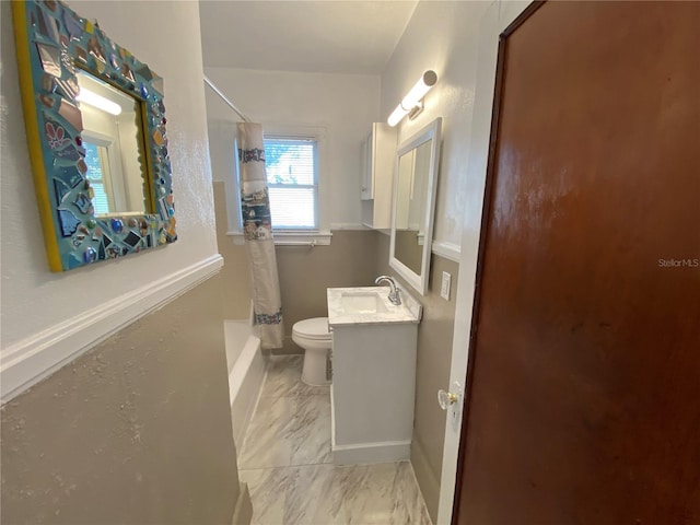 full bath featuring toilet, marble finish floor, shower / tub combo with curtain, and vanity