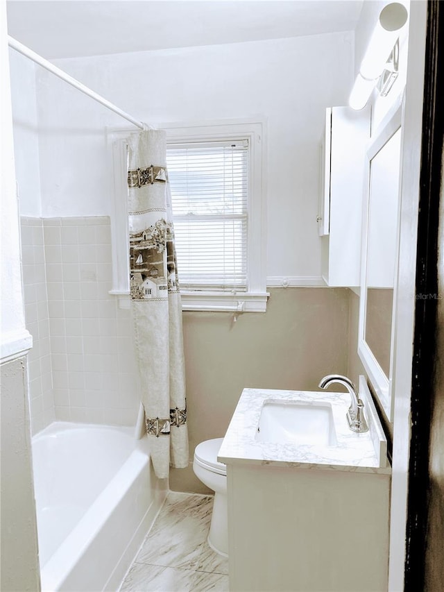 bathroom with marble finish floor, shower / bath combo, vanity, and toilet