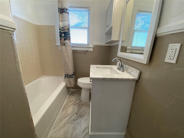 full bath with shower / bath combo, marble finish floor, vanity, and toilet