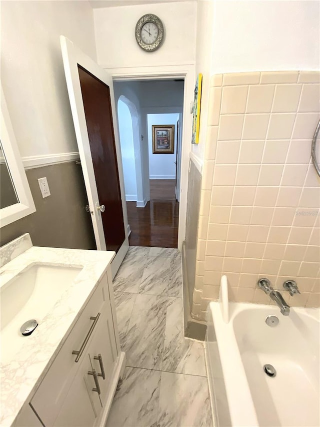 bathroom with marble finish floor and vanity