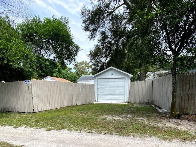 detached garage featuring fence