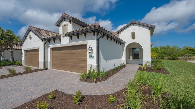 mediterranean / spanish-style house with a garage