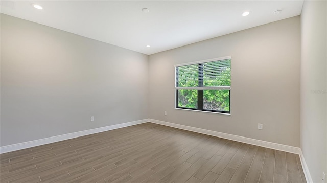 empty room with hardwood / wood-style floors