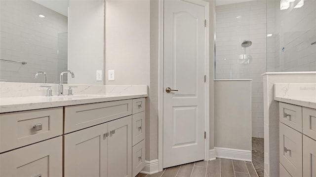 bathroom featuring vanity and tiled shower