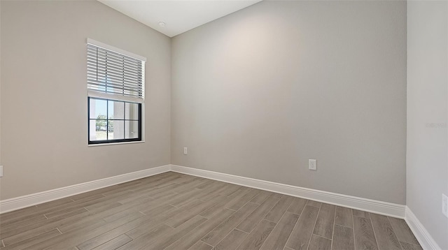 spare room featuring light hardwood / wood-style flooring