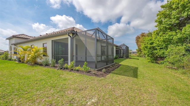 view of side of home featuring a lawn and a lanai