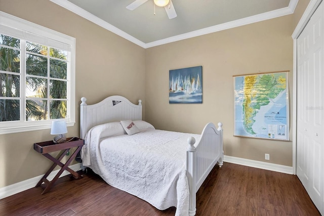 bedroom featuring crown molding, ceiling fan, a closet, and dark wood-type flooring