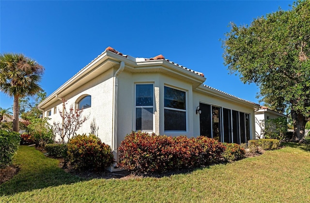 view of property exterior with a lawn