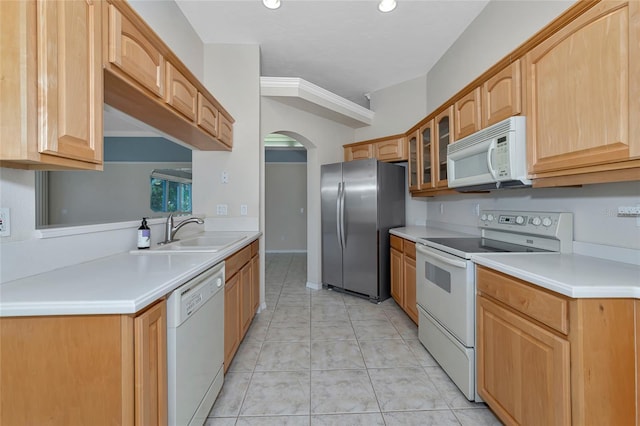 kitchen with light tile patterned floors, white appliances, ornamental molding, and sink