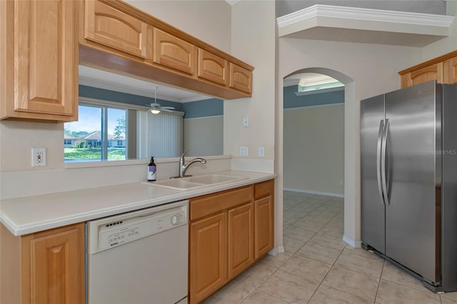 kitchen with ornamental molding, white dishwasher, ceiling fan, sink, and stainless steel refrigerator