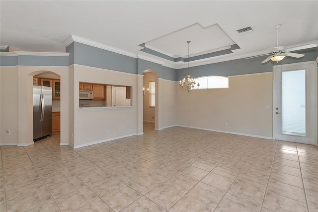 unfurnished living room with ceiling fan with notable chandelier and ornamental molding