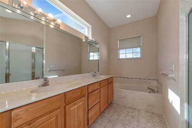 bathroom featuring plus walk in shower, vanity, and tile patterned flooring