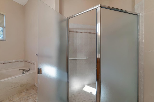 bathroom featuring plus walk in shower and tile patterned flooring