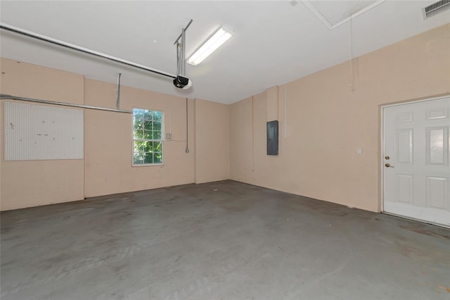 garage featuring electric panel and a garage door opener