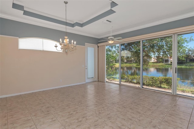 empty room with ceiling fan with notable chandelier, a water view, crown molding, and a tray ceiling