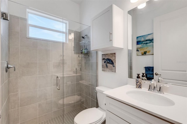 bathroom with walk in shower, vanity, and toilet