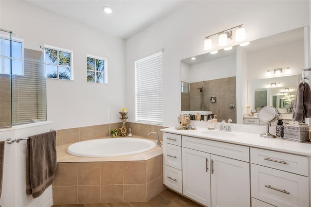 bathroom with vanity, tile patterned flooring, and plus walk in shower