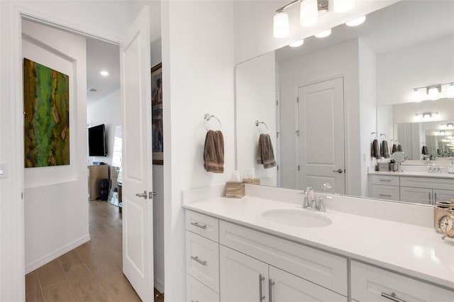 bathroom with vanity and wood-type flooring