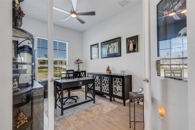 office area featuring ceiling fan, wood-type flooring, and french doors