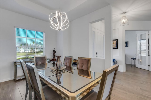 dining room with a chandelier and light hardwood / wood-style floors